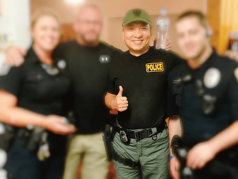 Eddie Wei Zhao with law enforcement officers